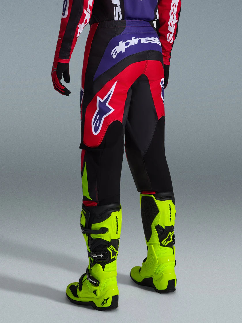 FLUID GRID PANT (Red/Black/Purple) | ALPINESTARS showcasing rear view with vibrant colors and off-road gear functionality.