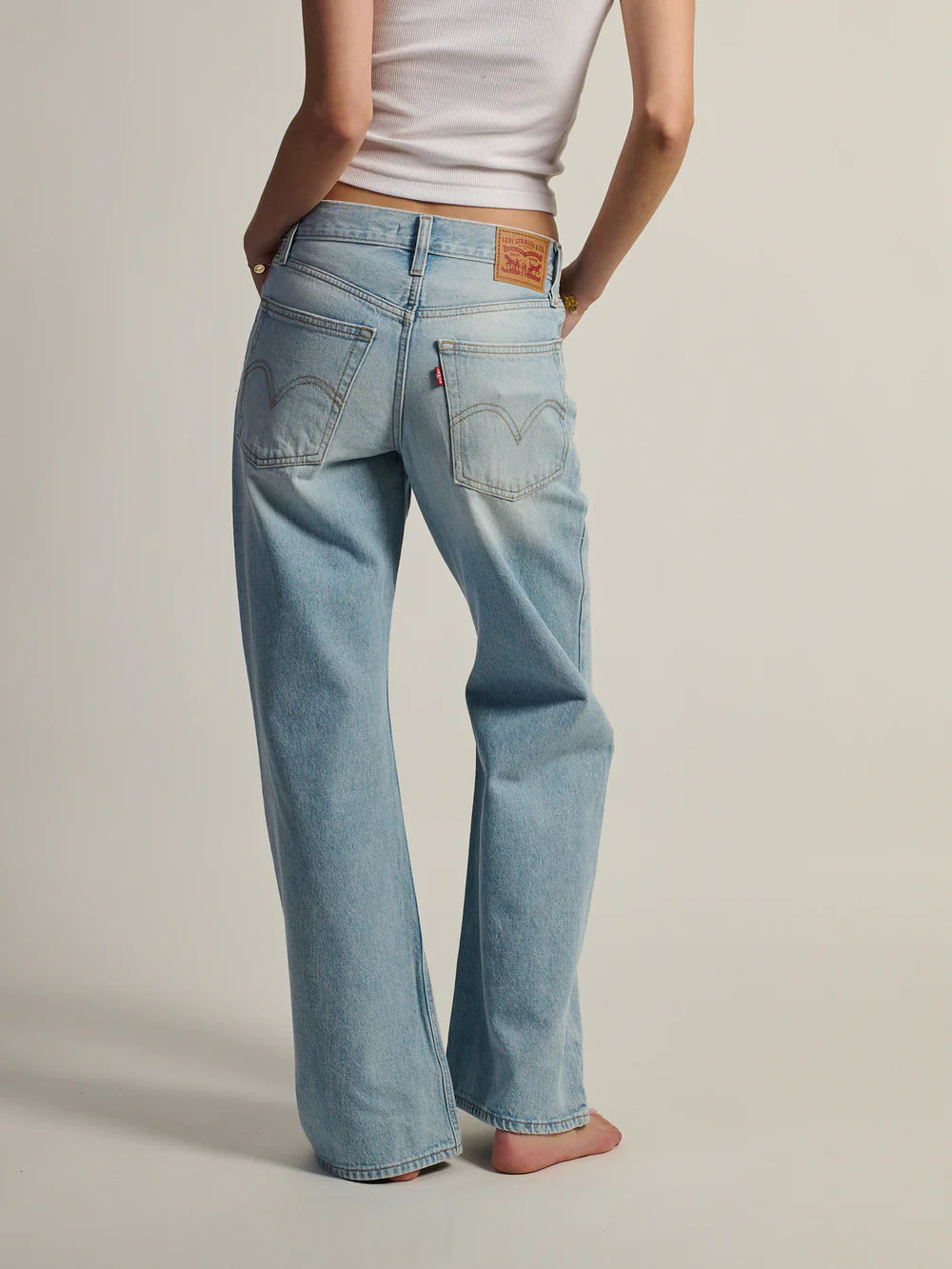 WOMEN'S MIDDY LOOSE BOOT CUT JEAN (Abraided Art) | LEVI'S showcased from the back, displaying light wash color and relaxed fit.