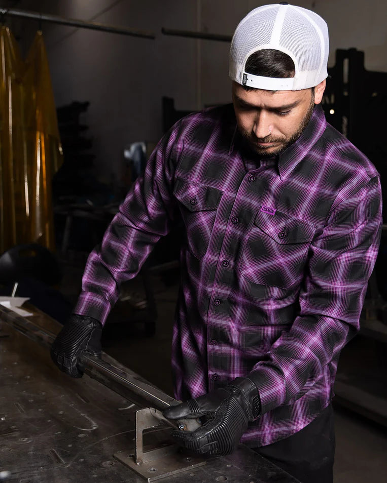 MEN'S ARGON FLANNEL (Purple/Black) | DIXXON worn by a man working in a workshop, showcasing the stylish plaid design.