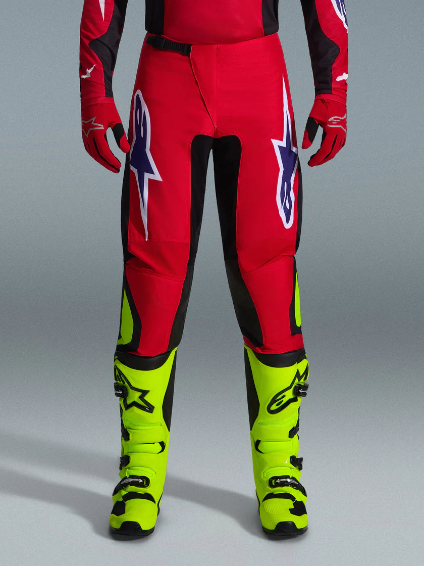 FLUID GRID PANT (Red/Black/Purple) | ALPINESTARS worn by a rider, showcasing vibrant colors and design for off-road riding.