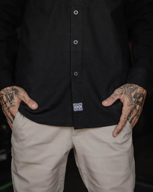MEN'S LONG SLEEVE WORKSHIRT (Black) | DIXXON worn by model showing rugged style and durability in performance wear.