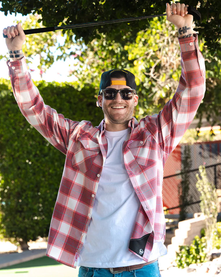 MEN'S HAPPY LAND FLANNEL (Red/White) | DIXXON model smiling outdoors, wearing plaid shirt, showcasing casual style.