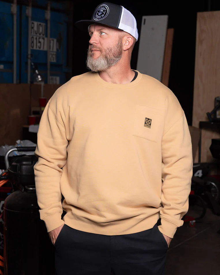 MEN'S POCKET CREWNECK (Khaki) | DIXXON model wearing khaki sweatshirt in casual setting.