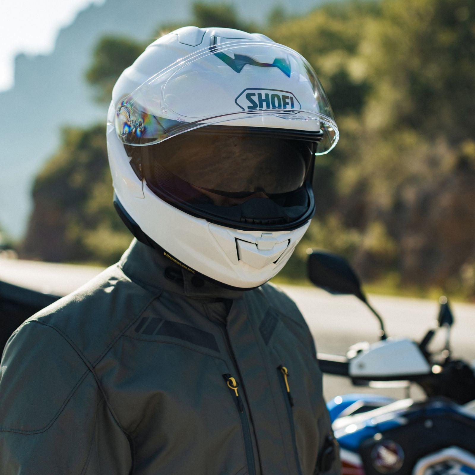 GT-AIR 3 FULL FACE HELMET (White) | SHOEI worn by a rider in a scenic outdoor setting.