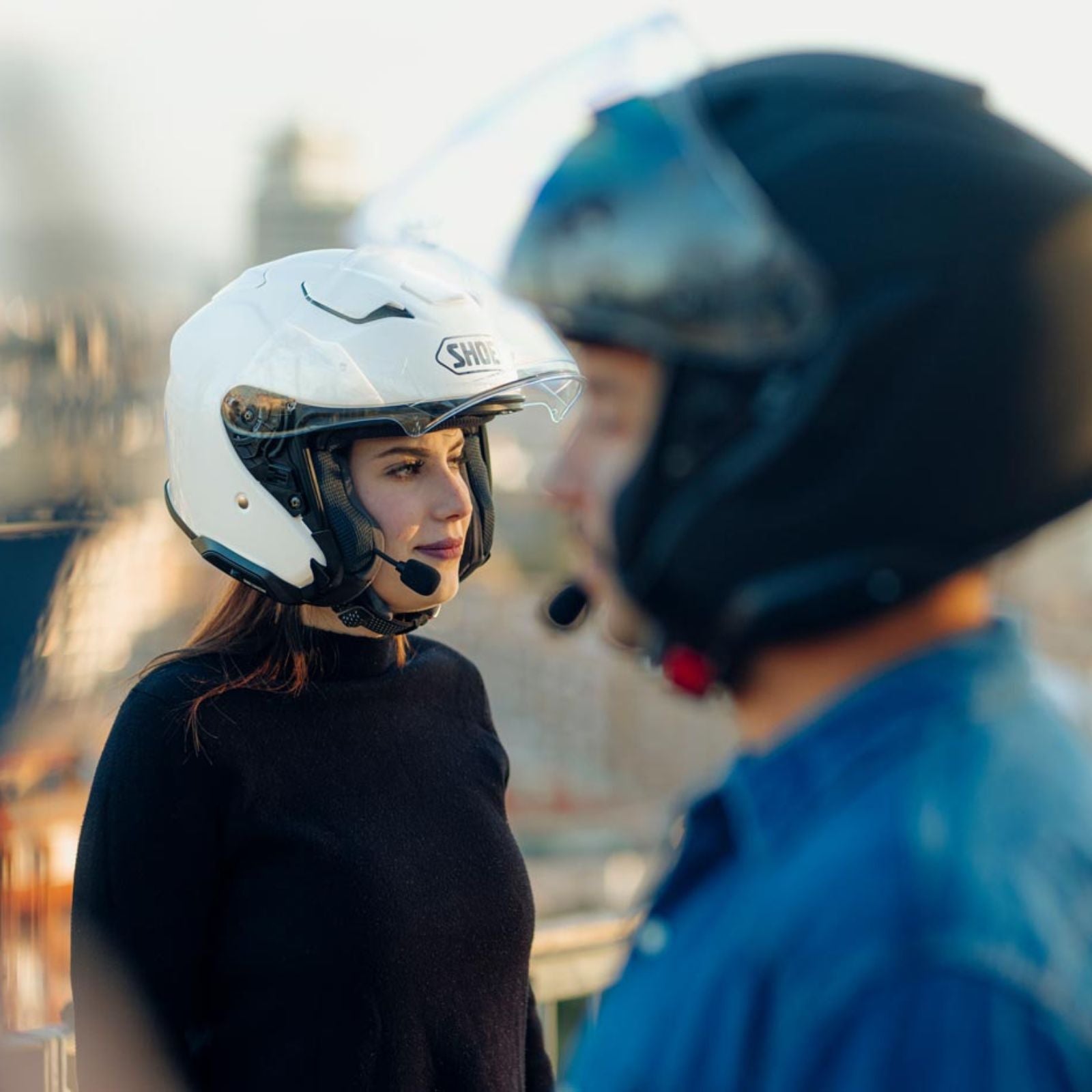 J-CRUISE 3 OPEN FACE HELMET (White) | SHOEI worn by a woman with a male rider in background, ideal for touring.